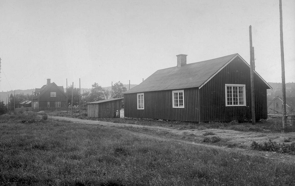 Svartvit gammal bild på kanalinspektörsbostaden samt ett annat hus. 