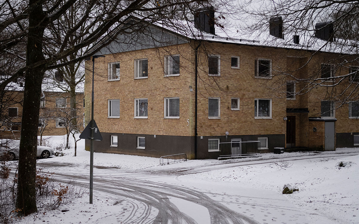 Ett tvåvåningshus i gult tegel i ett snöigt landskap.