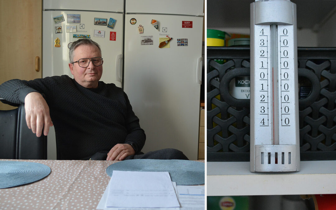 Mikael Hällgren sitter vid köksbordet. En termometer visar tio-elva grader.