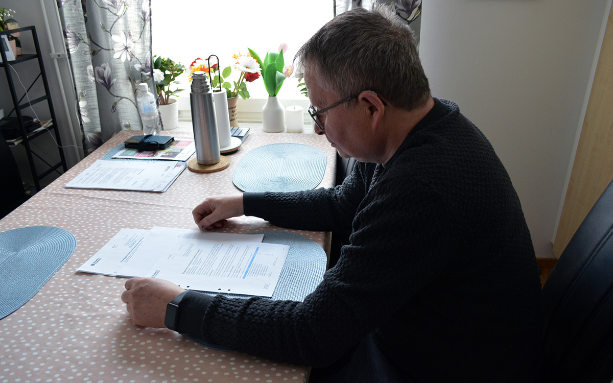 Mikael läser besiktning som konstaterar att det varit kallt i lägenheten.